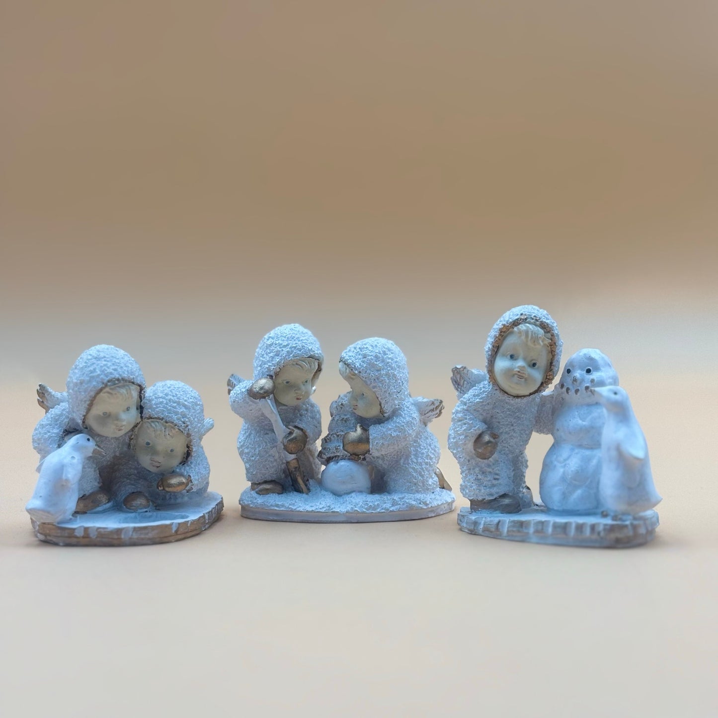 Textured Vintage resin 5 piece winter wonderland figurine with snow men and penguins
