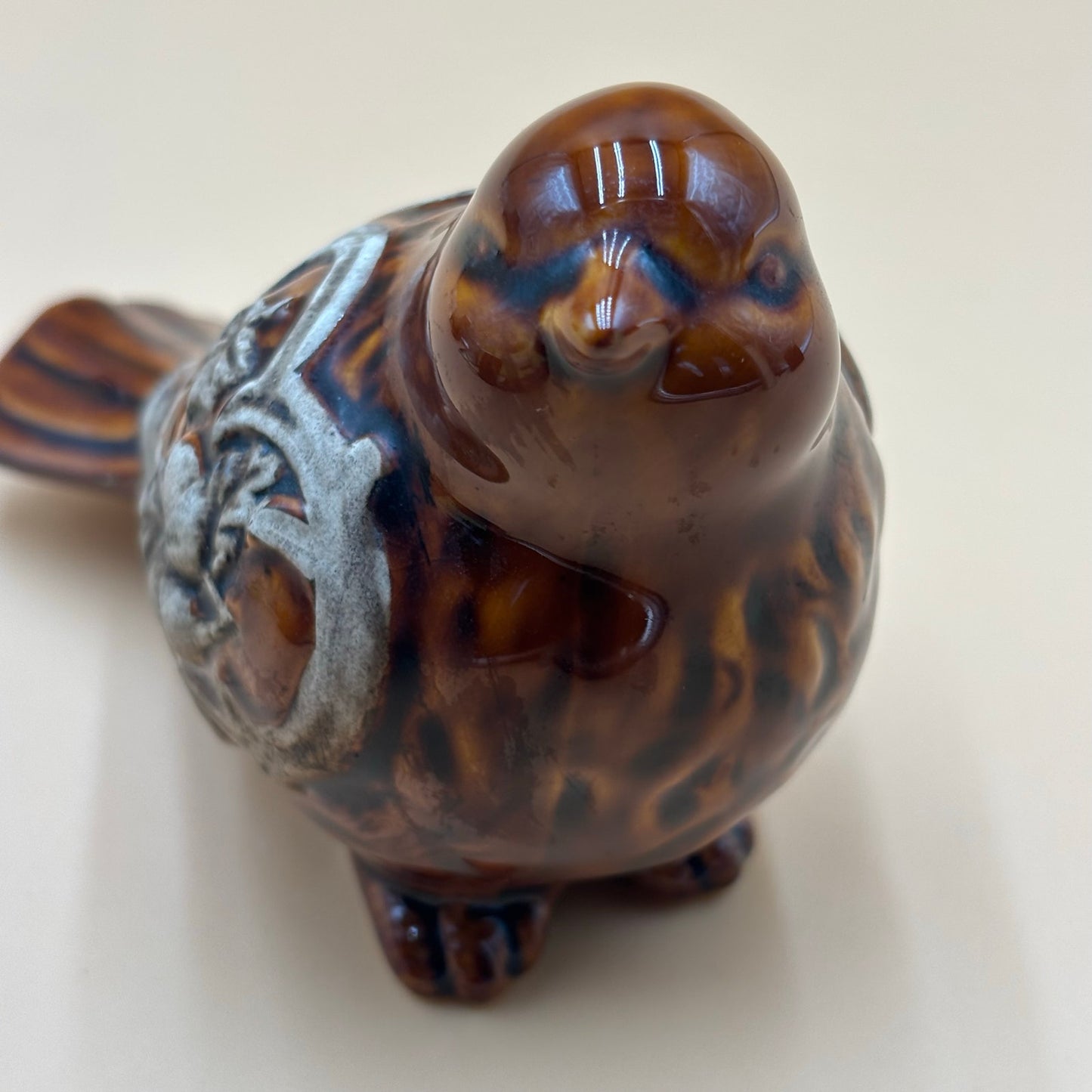 Brown Glazed Ceramic Bird Figurine with Raised Leaf and Vine Detail