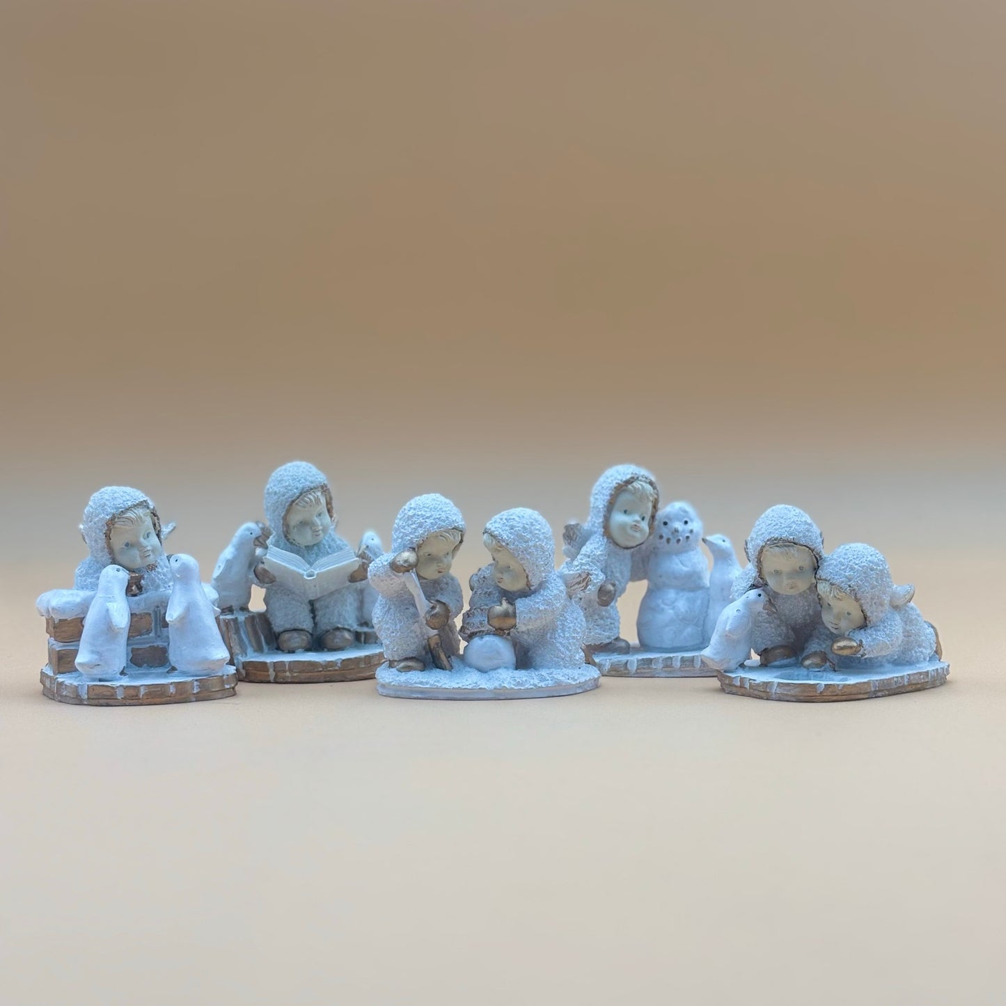 Textured Vintage resin 5 piece winter wonderland figurine with snow men and penguins