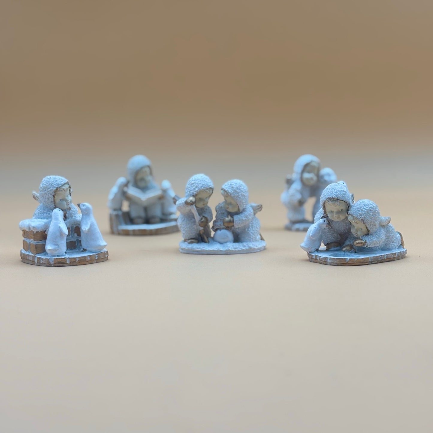 Textured Vintage resin 5 piece winter wonderland figurine with snow men and penguins