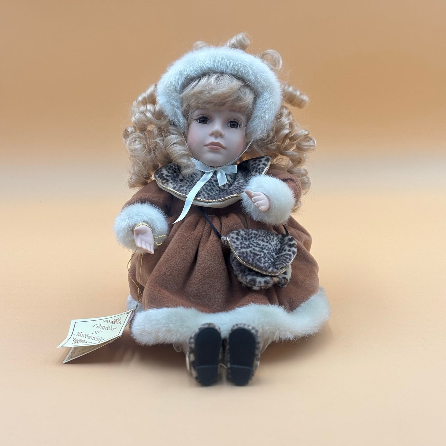Collector’s Choice Animated Musical Porcelain Doll with Faux Fur & Leopard Trim Coat