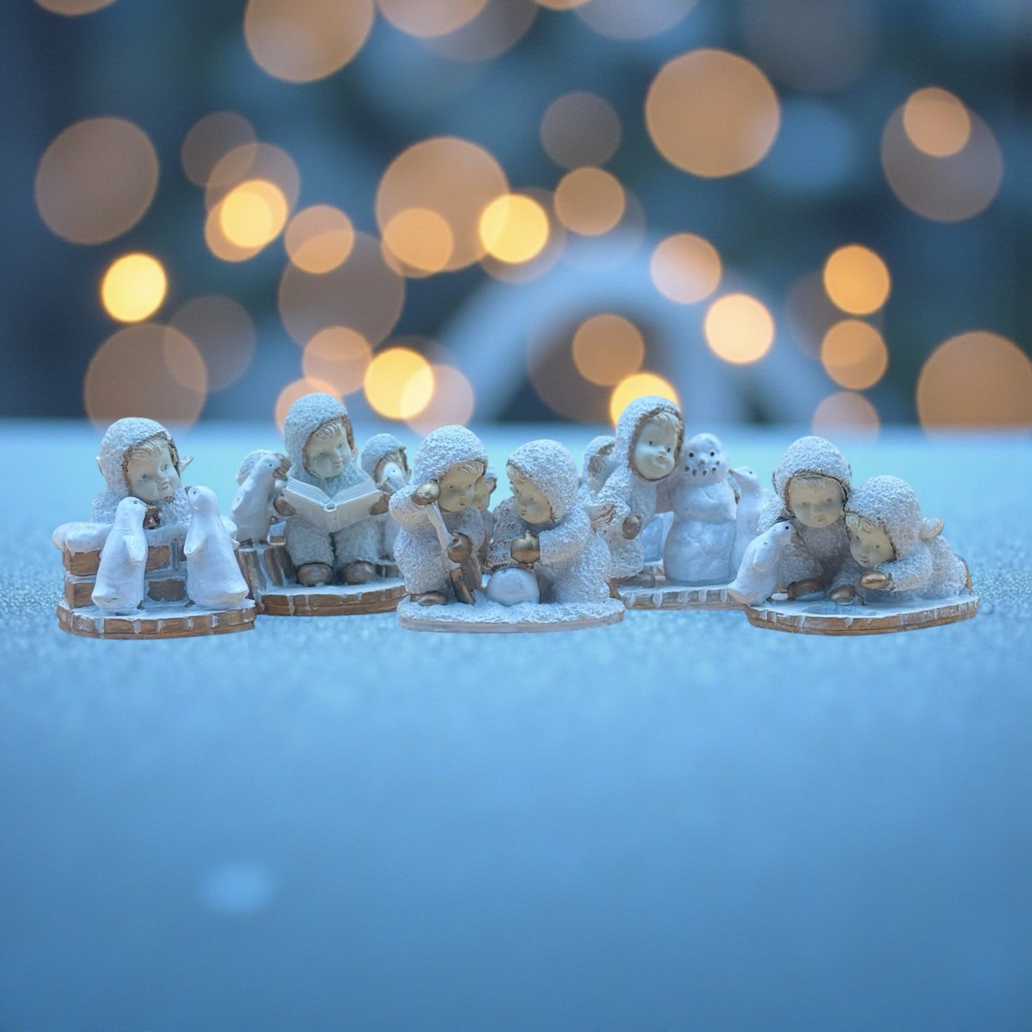 Textured Vintage resin 5 piece winter wonderland figurine with snow men and penguins