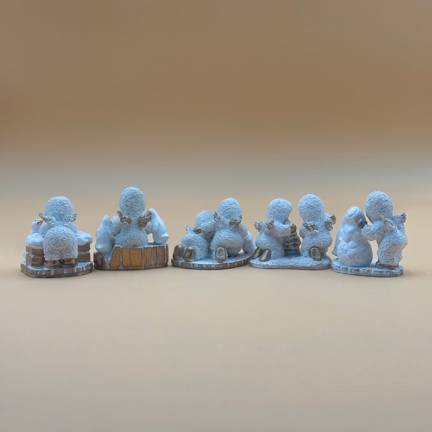 Textured Vintage resin 5 piece winter wonderland figurine with snow men and penguins