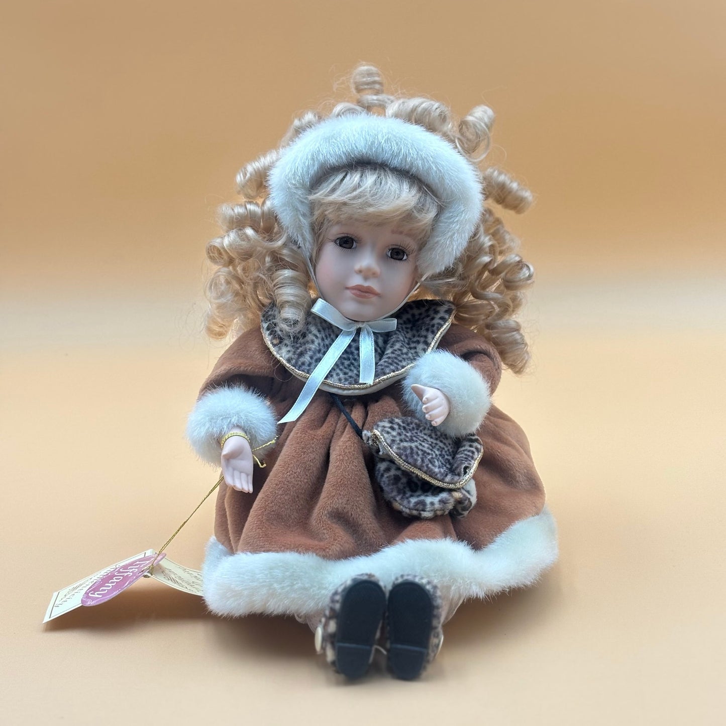 Collector’s Choice Animated Musical Porcelain Doll with Faux Fur & Leopard Trim Coat