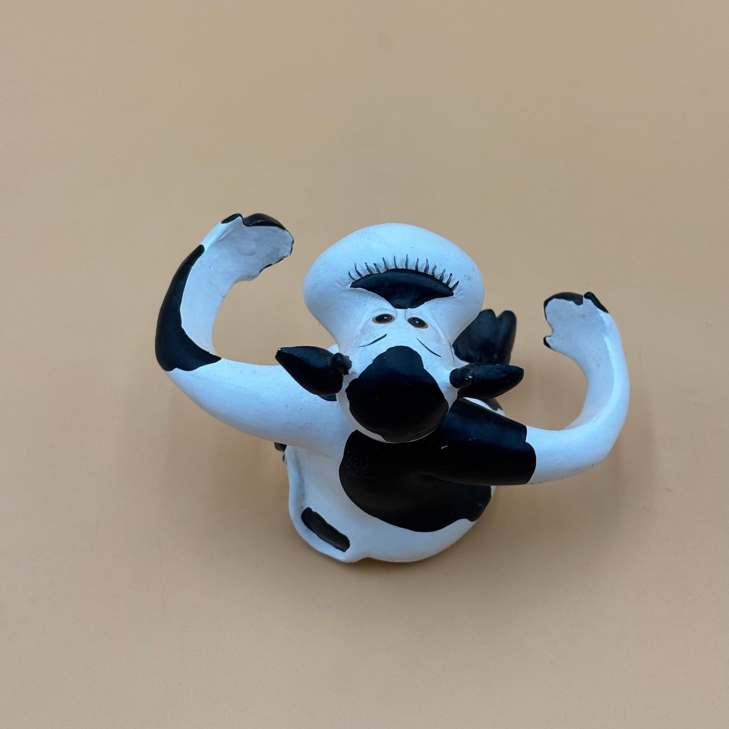 Stretch-Arm Cow Figurine – L Dake & Ln Vintage Stone Like