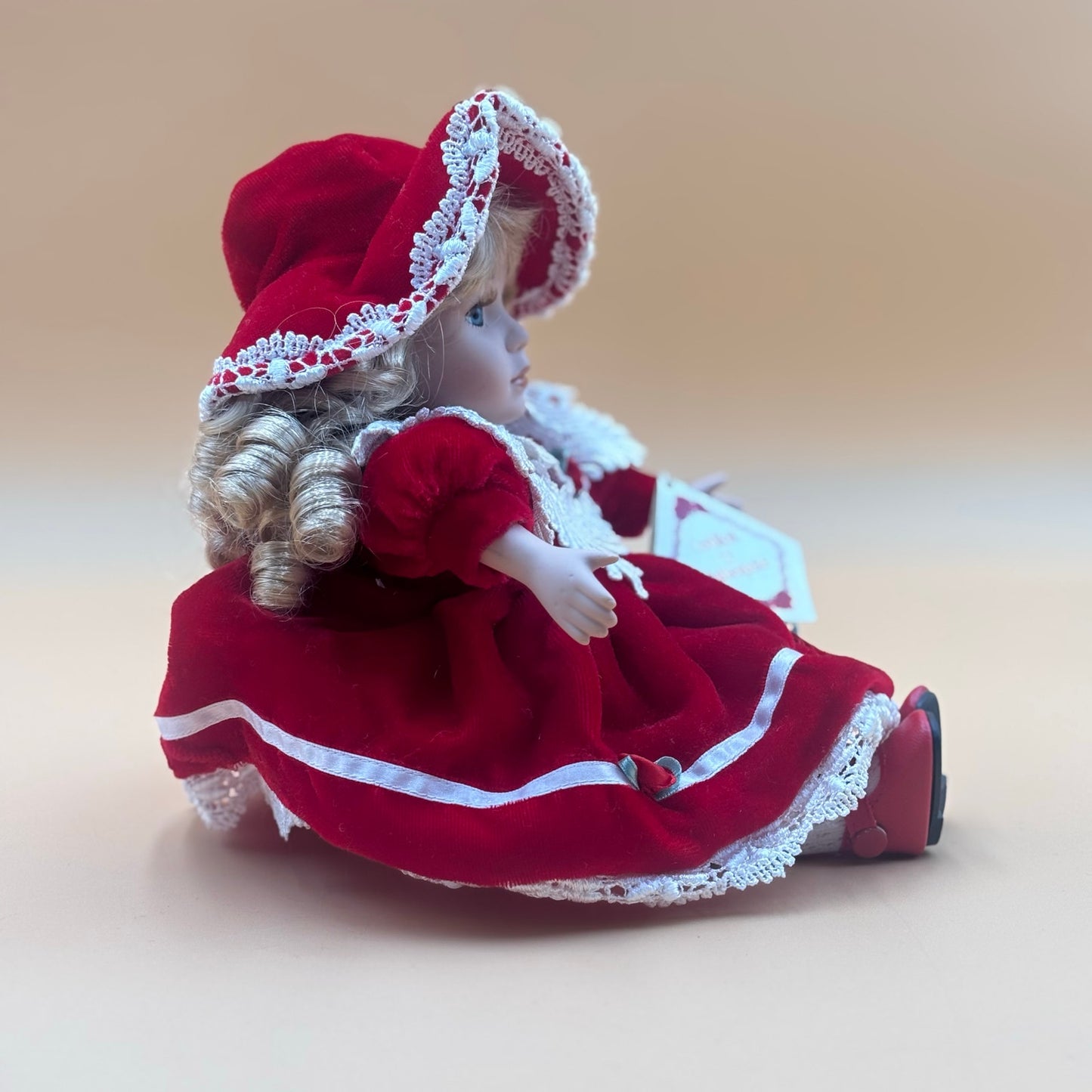 Collector’s Choice Musical Porcelain Doll in Red Velvet Dress with Bonnet