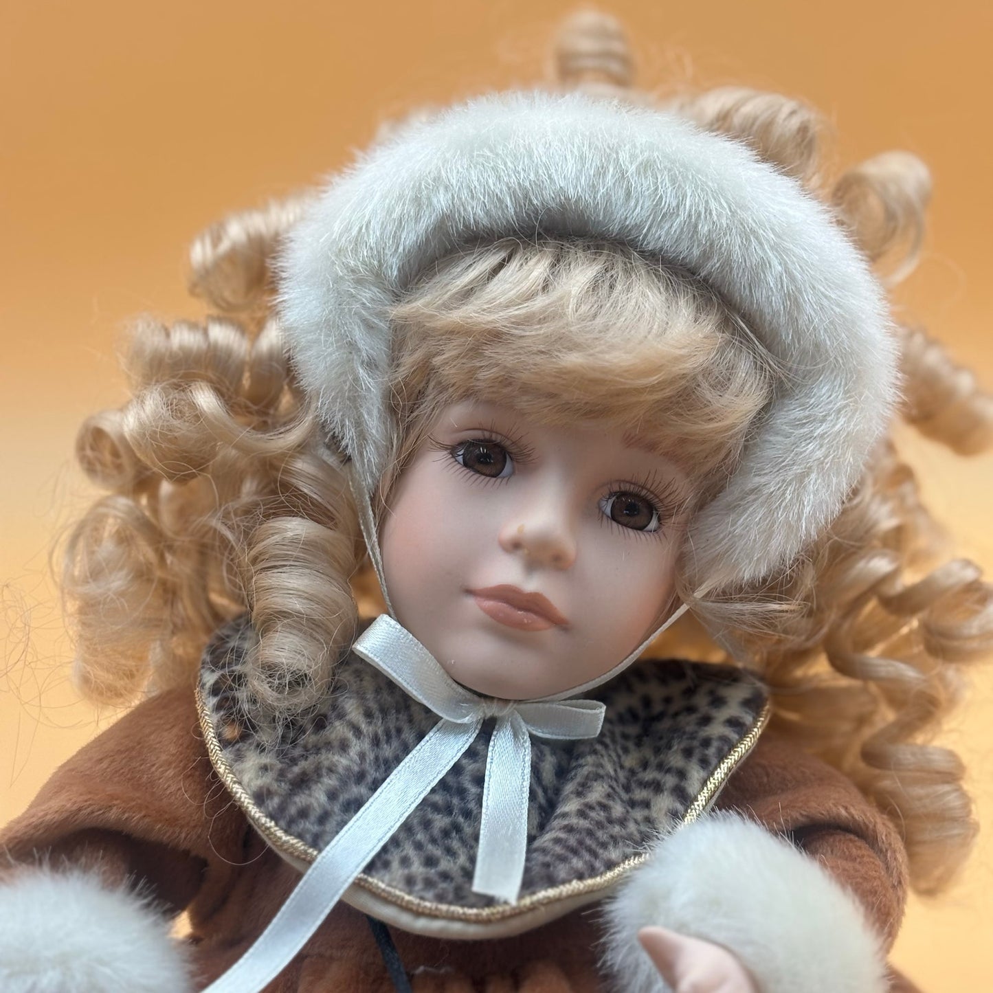 Collector’s Choice Animated Musical Porcelain Doll with Faux Fur & Leopard Trim Coat
