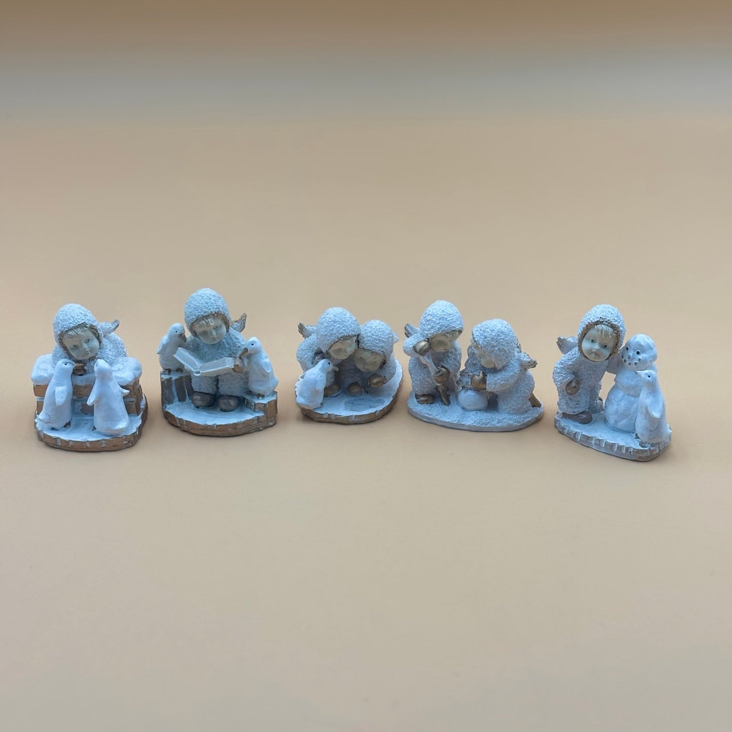 Textured Vintage resin 5 piece winter wonderland figurine with snow men and penguins