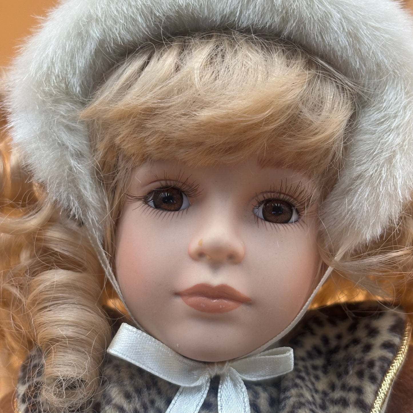 Collector’s Choice Animated Musical Porcelain Doll with Faux Fur & Leopard Trim Coat